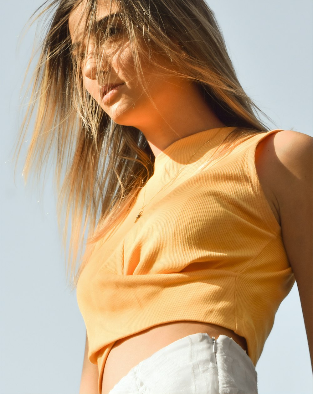 woman in yellow sleeveless shirt