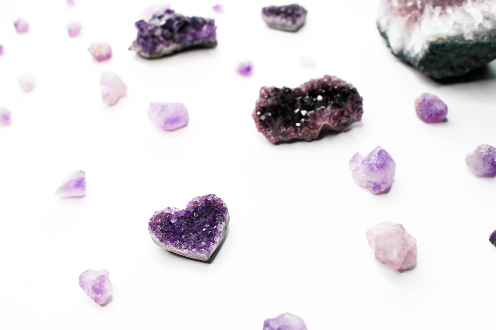 purple and white stones on white surface