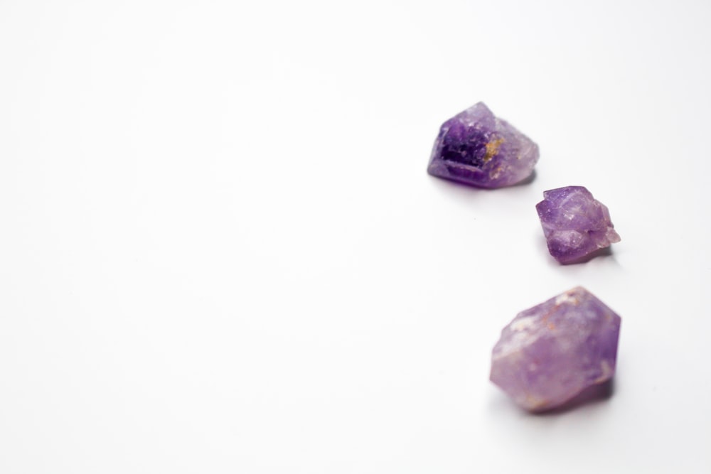 purple and brown stones on white surface