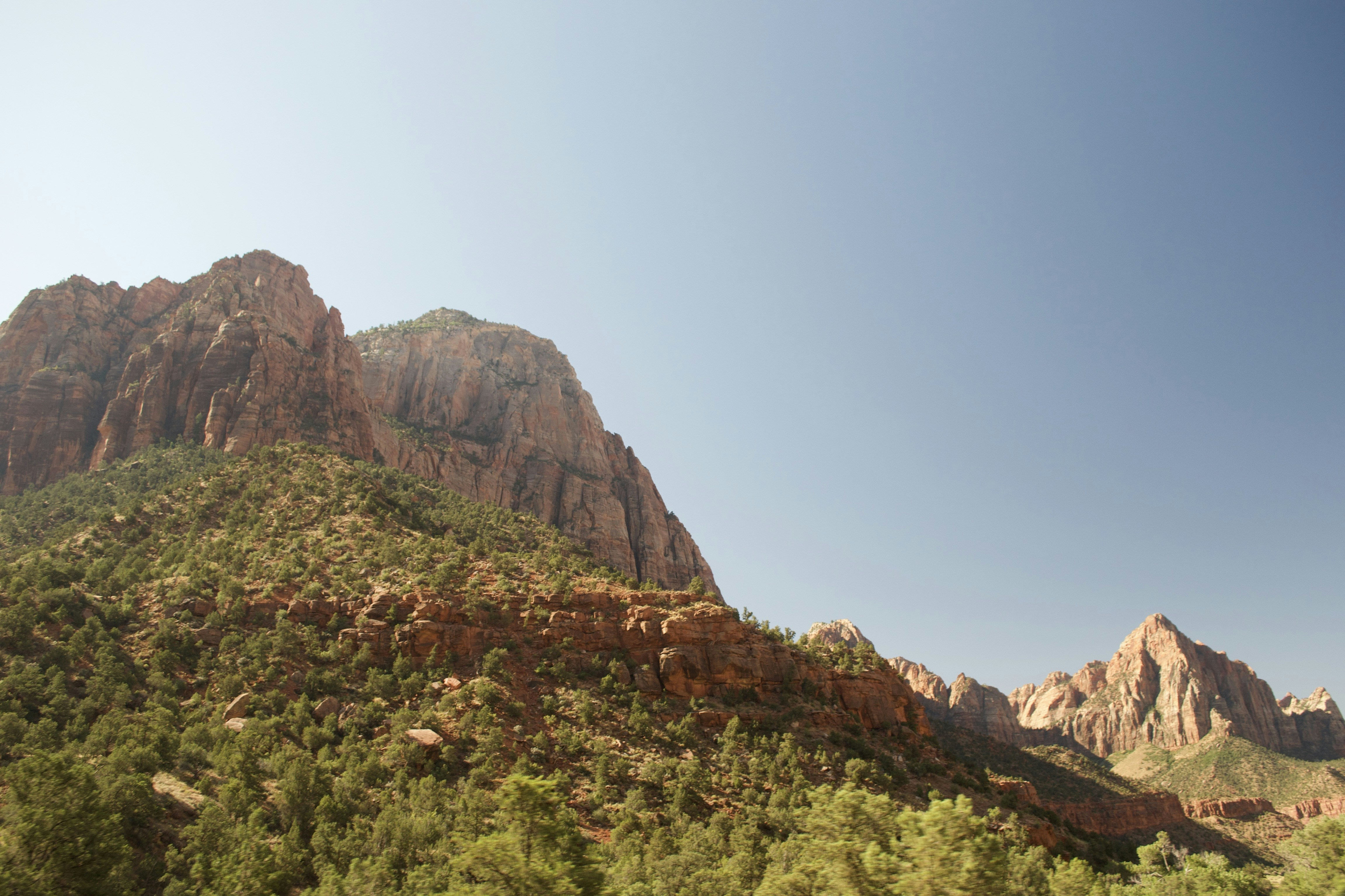 green and brown mountain under blue sky during daytime