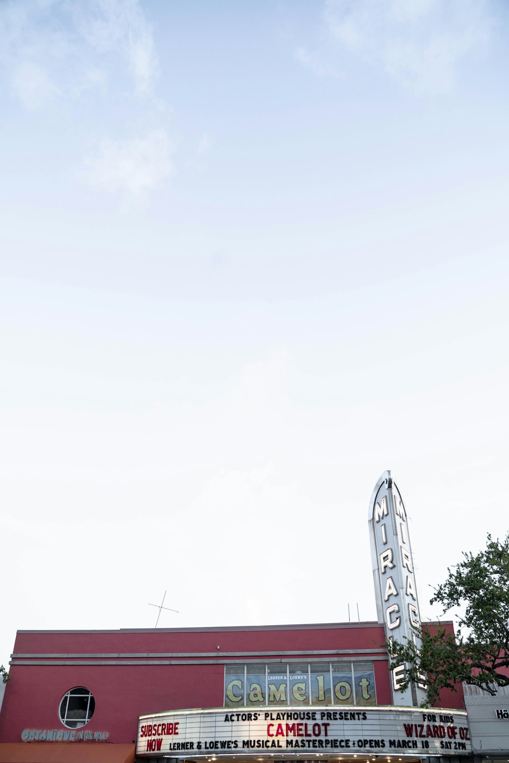 white and red concrete building under white sky during daytime