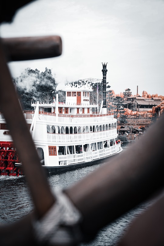 white and red ship on sea during daytime in Tokyo Disneyland Japan