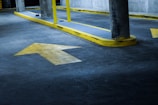 Directional arrows painted on a busy parking lot.