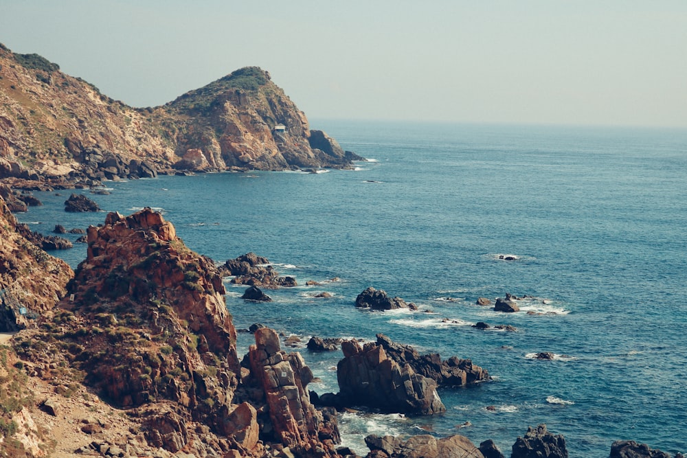 brown rock formation on sea during daytime