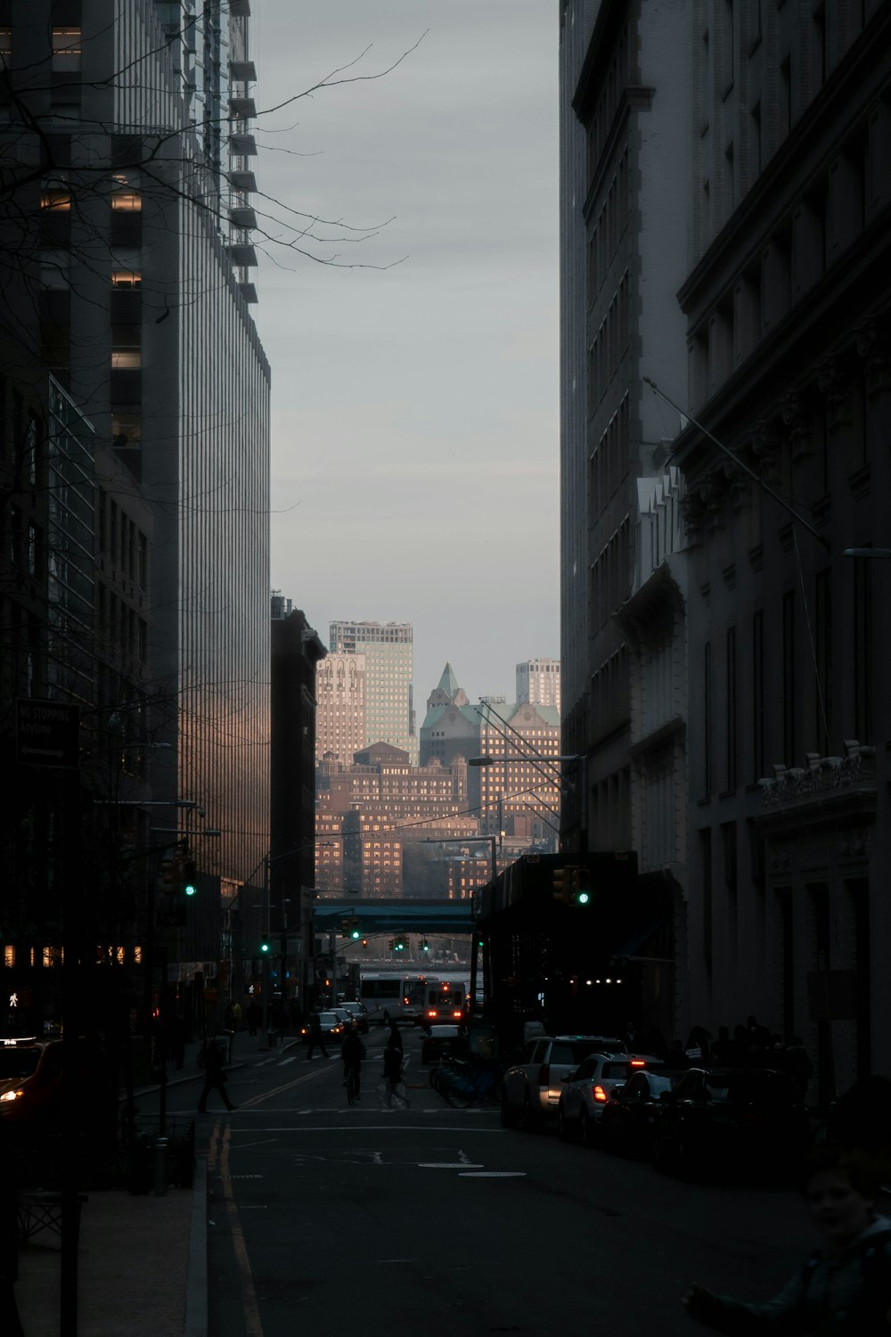 cars on road between high rise buildings during daytime