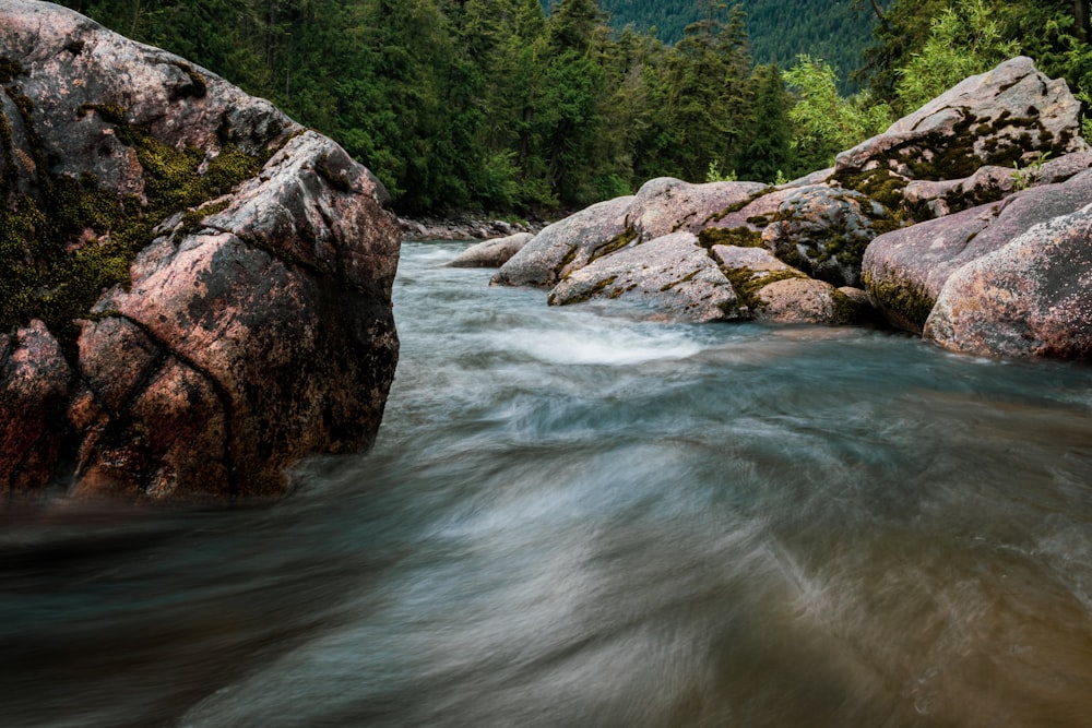 brown rock formation beside river during daytime