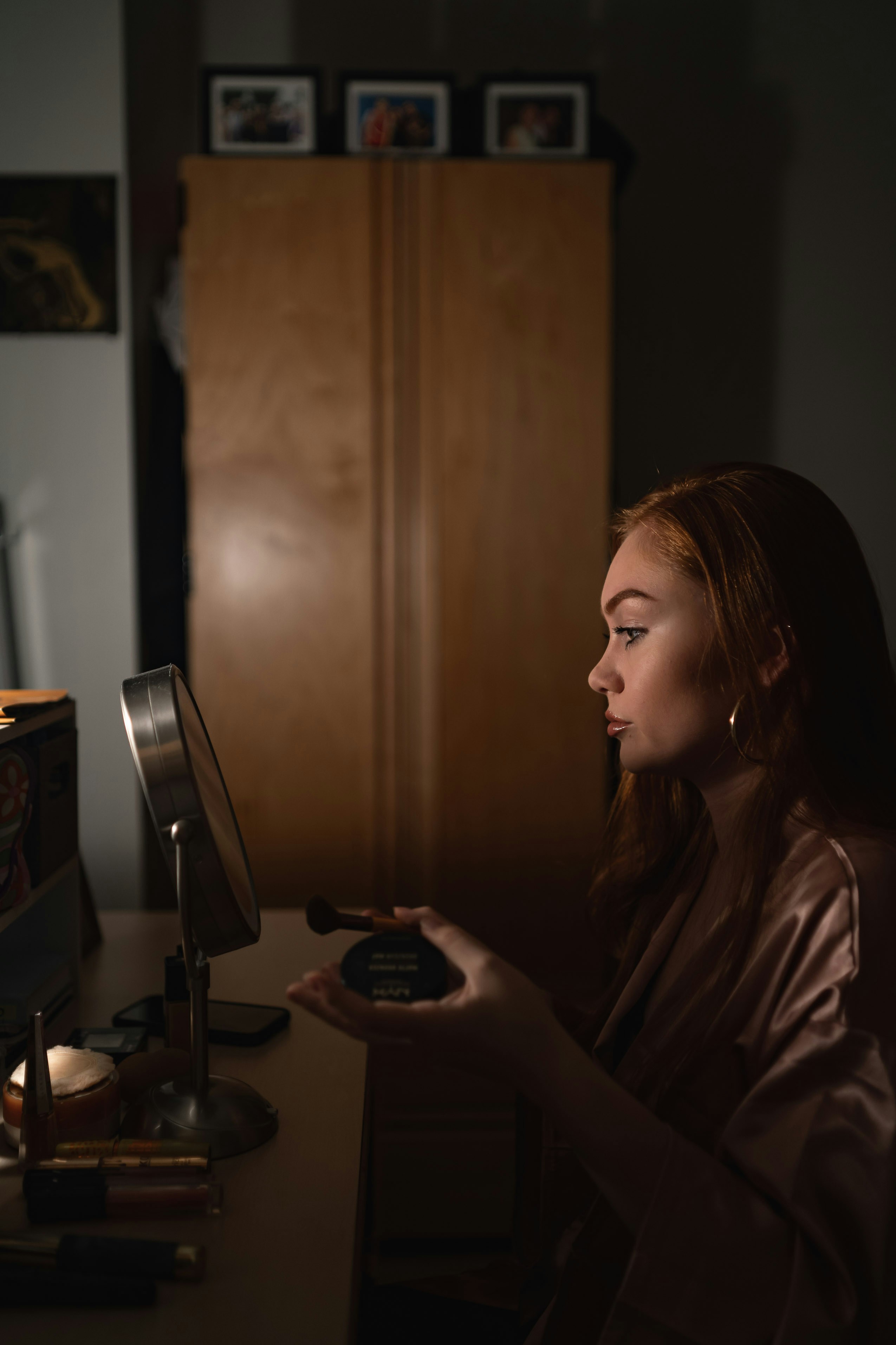 woman in brown shirt holding black and silver coffee maker