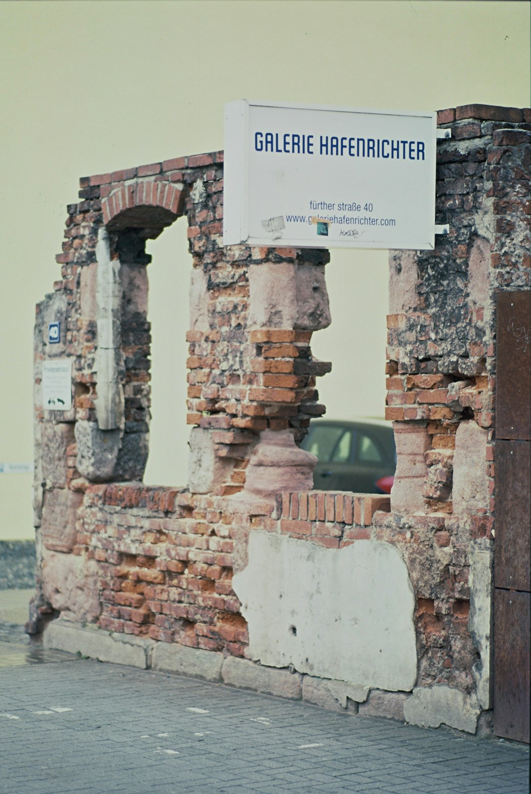 brown brick wall with white and black sign