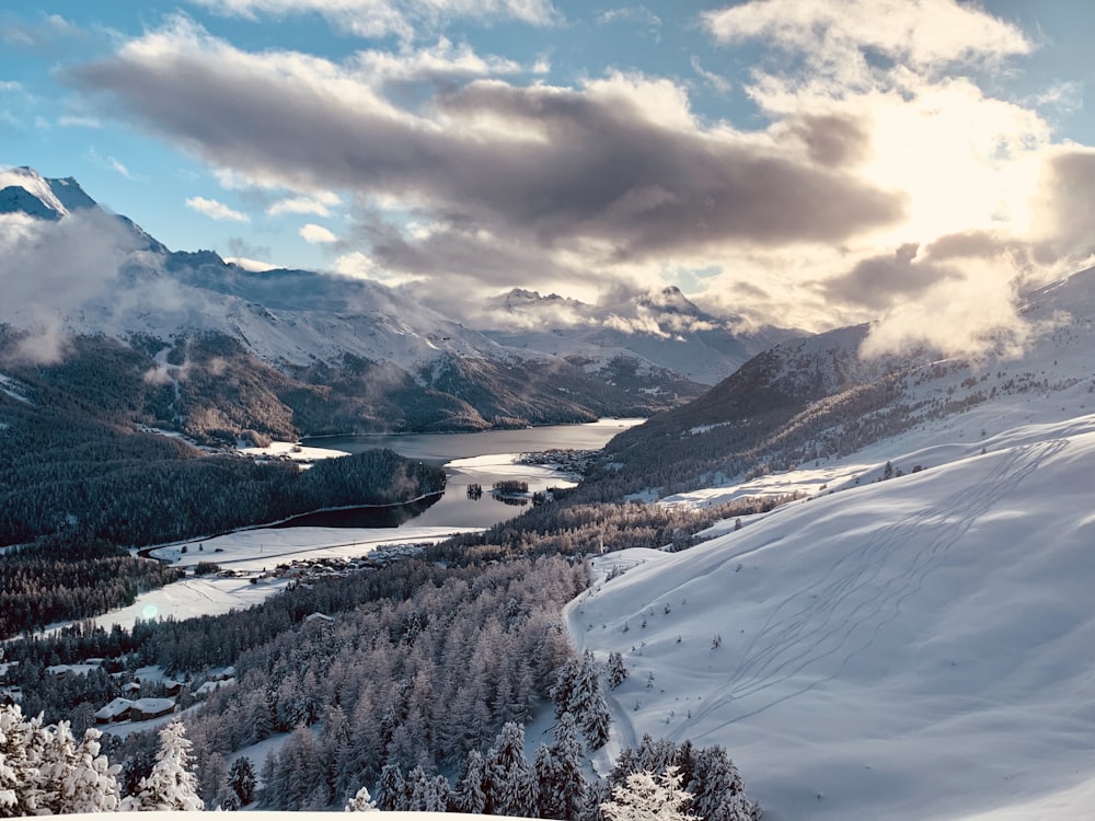 snow covered mountain under cloudy sky during daytime