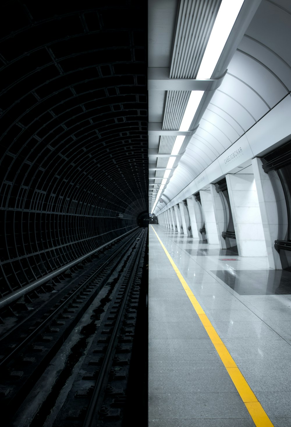 black train rail in tunnel