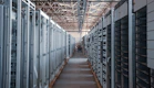 server room aisle with metal equipment racks
