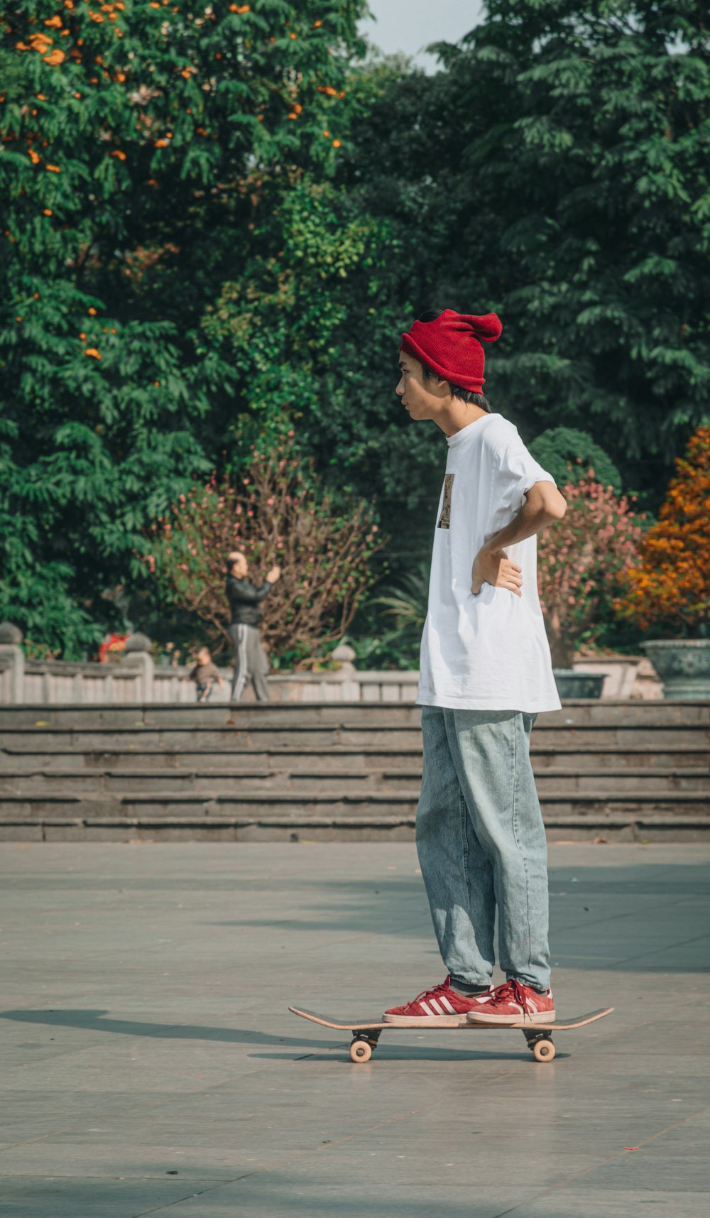 man in white button up shirt and gray pants standing on gray concrete pavement during daytime