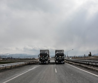 blue and white truck on road during daytime