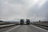 blue and white truck on road during daytime
