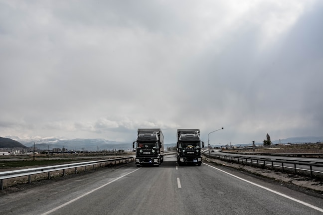 blue and white truck on road during daytime