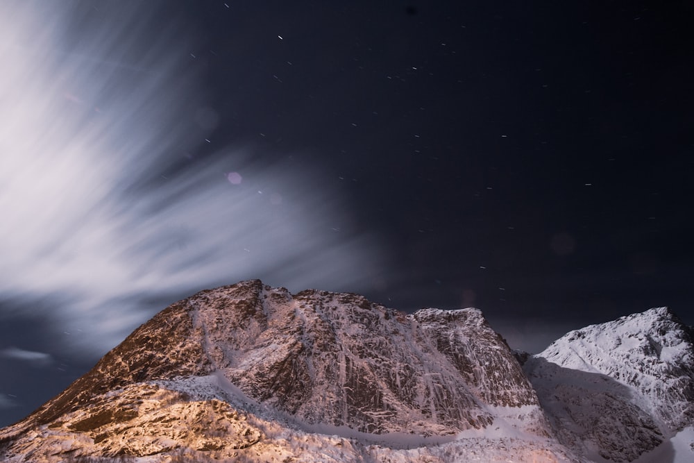 brown rocky mountain under blue sky during night time