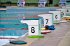 white and green wooden stand on swimming pool