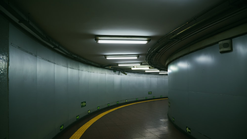 white and gray hallway with green and yellow chairs