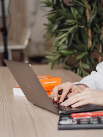 person in white dress shirt using black laptop computer