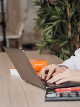 person in white dress shirt using black laptop computer