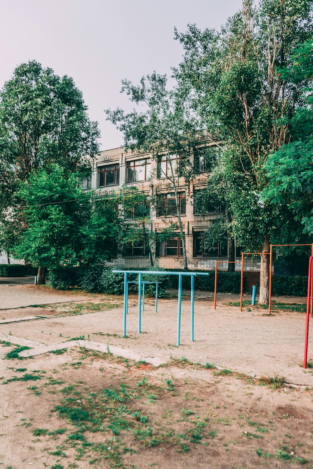 green trees near brown concrete building during daytime