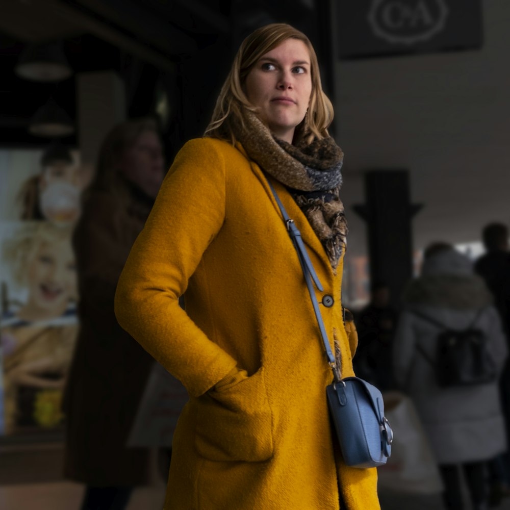 woman in brown coat standing