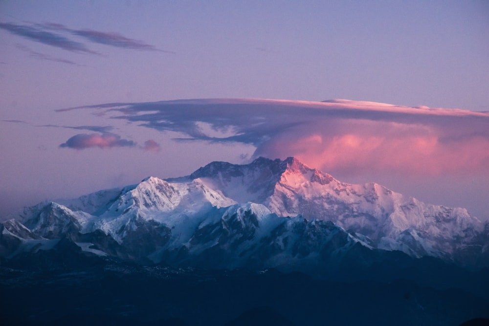 snow covered mountain under gray sky