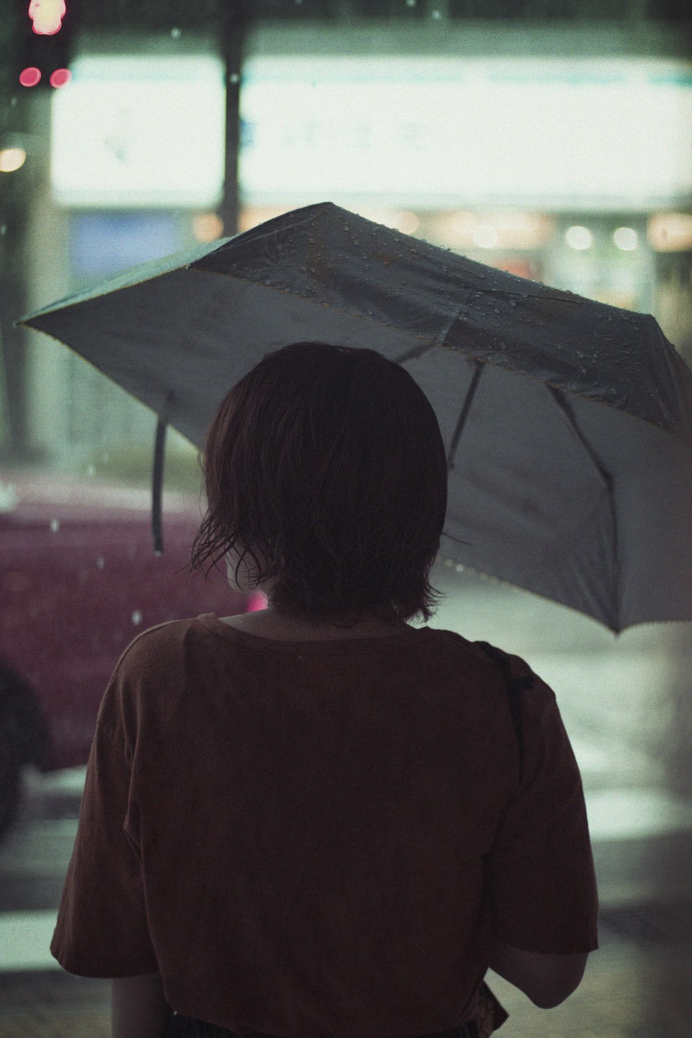 woman in black coat holding umbrella during daytime