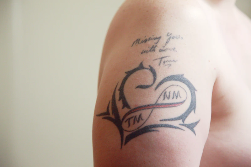 Faded, blurred name tattoo before cover-up
