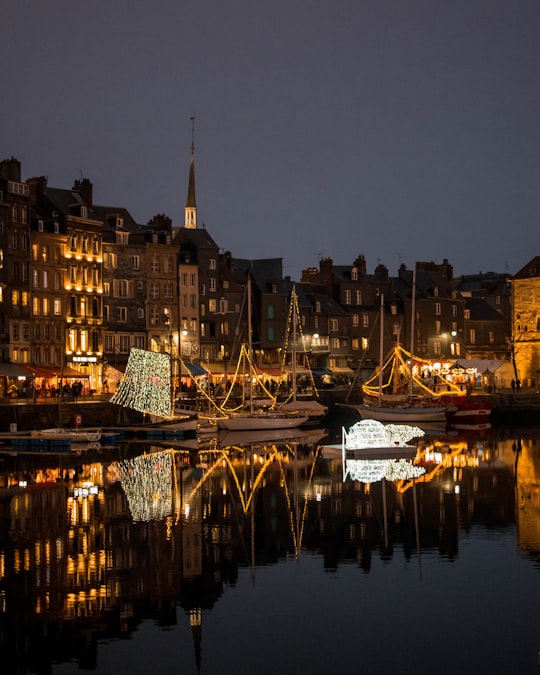 white and black boat on body of water during night time in Port of Honfleur France