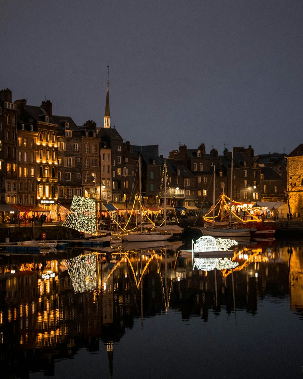 white and black boat on body of water during night time