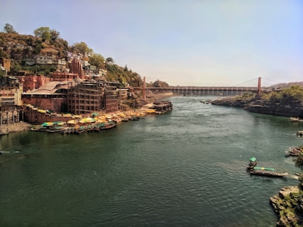 boat on river near bridge during daytime