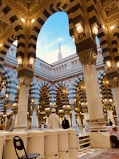 people walking on pathway near brown concrete building during daytime