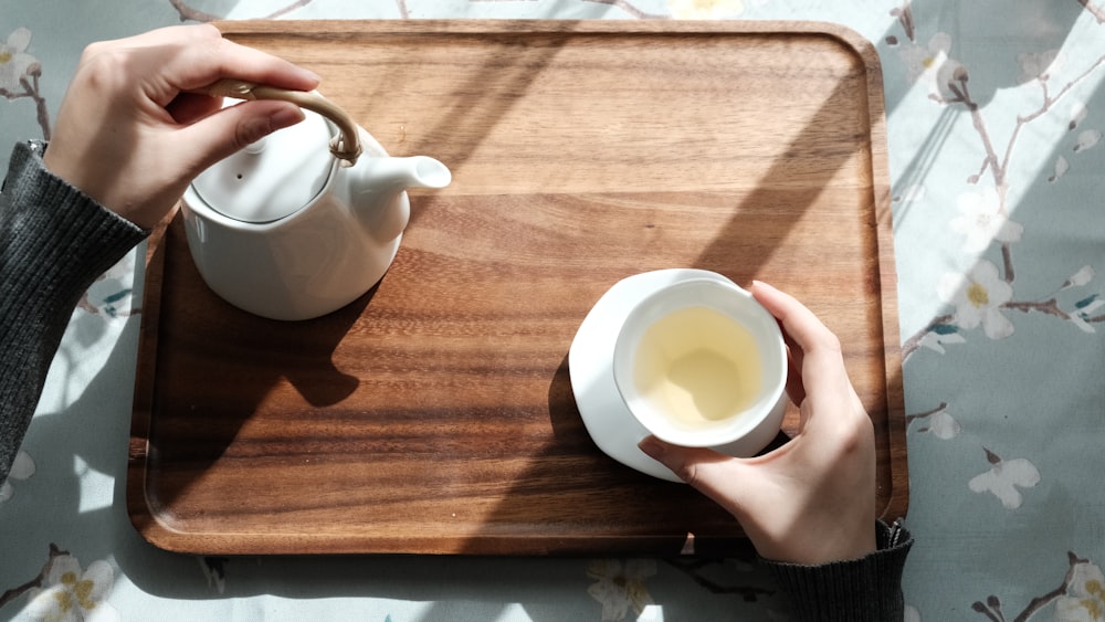 white ceramic teapot on brown wooden table