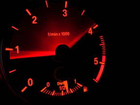 black and red speedometer at 0