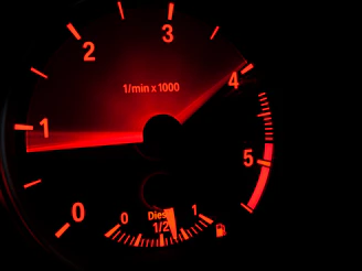 black and red speedometer at 0