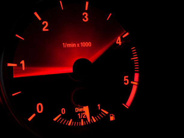 black and neon orange speedometer at 4