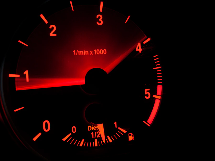 Close-up of a car tachometer needle resting near zero, representing the rev range debate between rev-happy and torquey engines