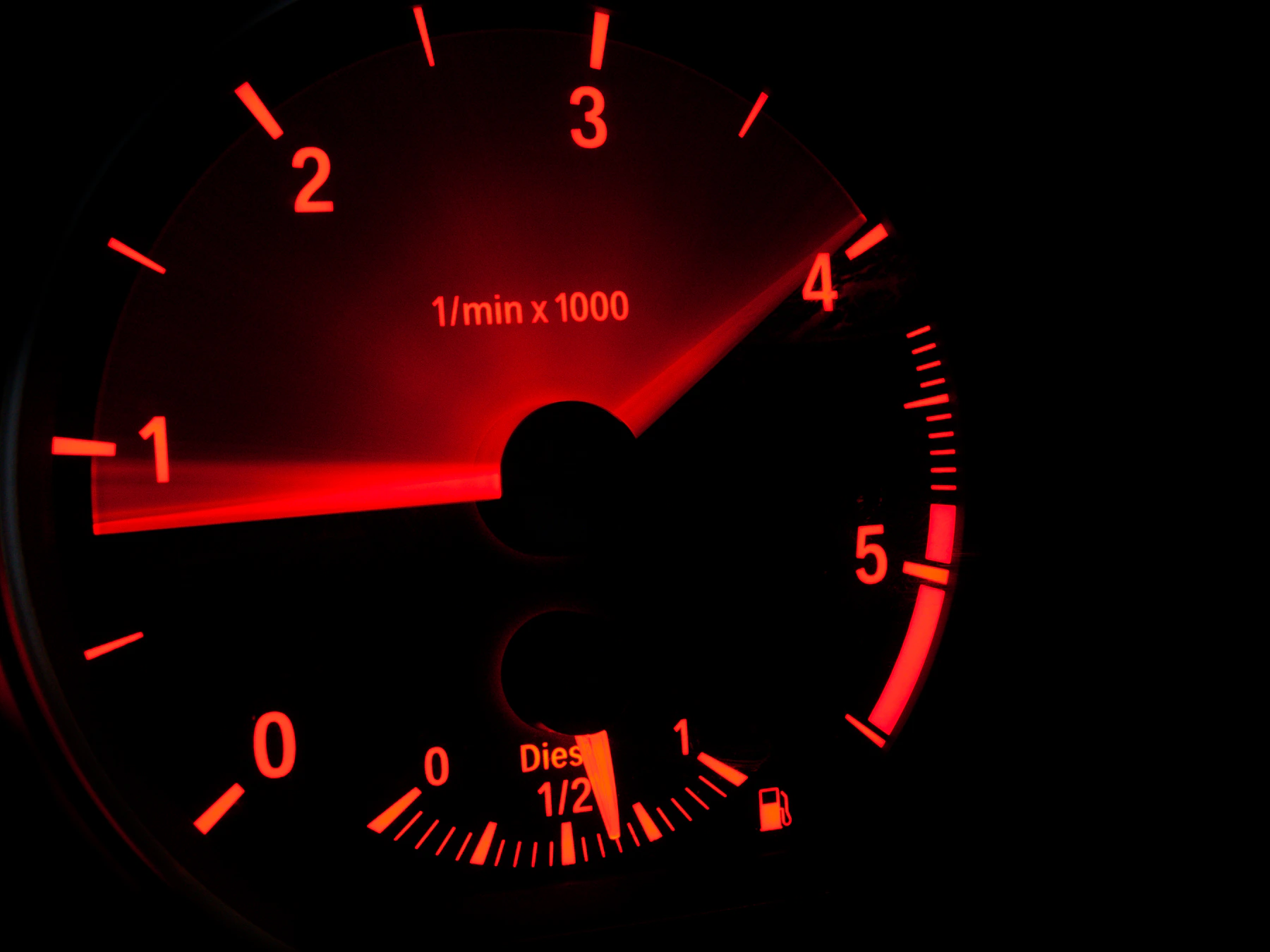Close-up of a car tachometer needle resting near zero, representing the rev range debate between rev-happy and torquey engines