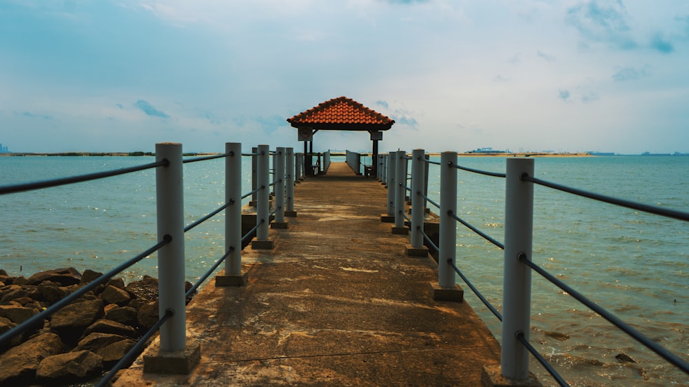 brown wooden dock on blue sea under blue sky during daytime