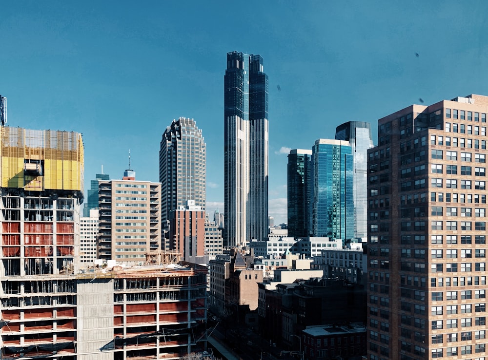 city skyline under blue sky during daytime