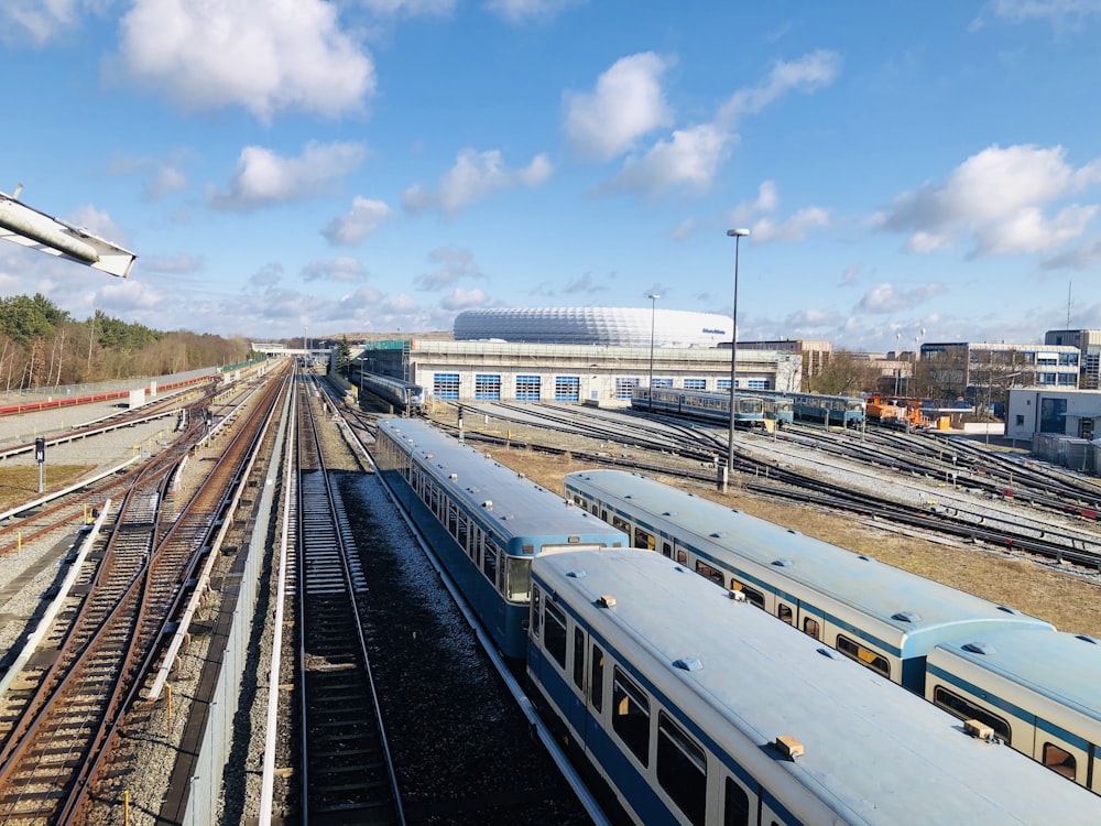white train on rail under blue sky during daytime