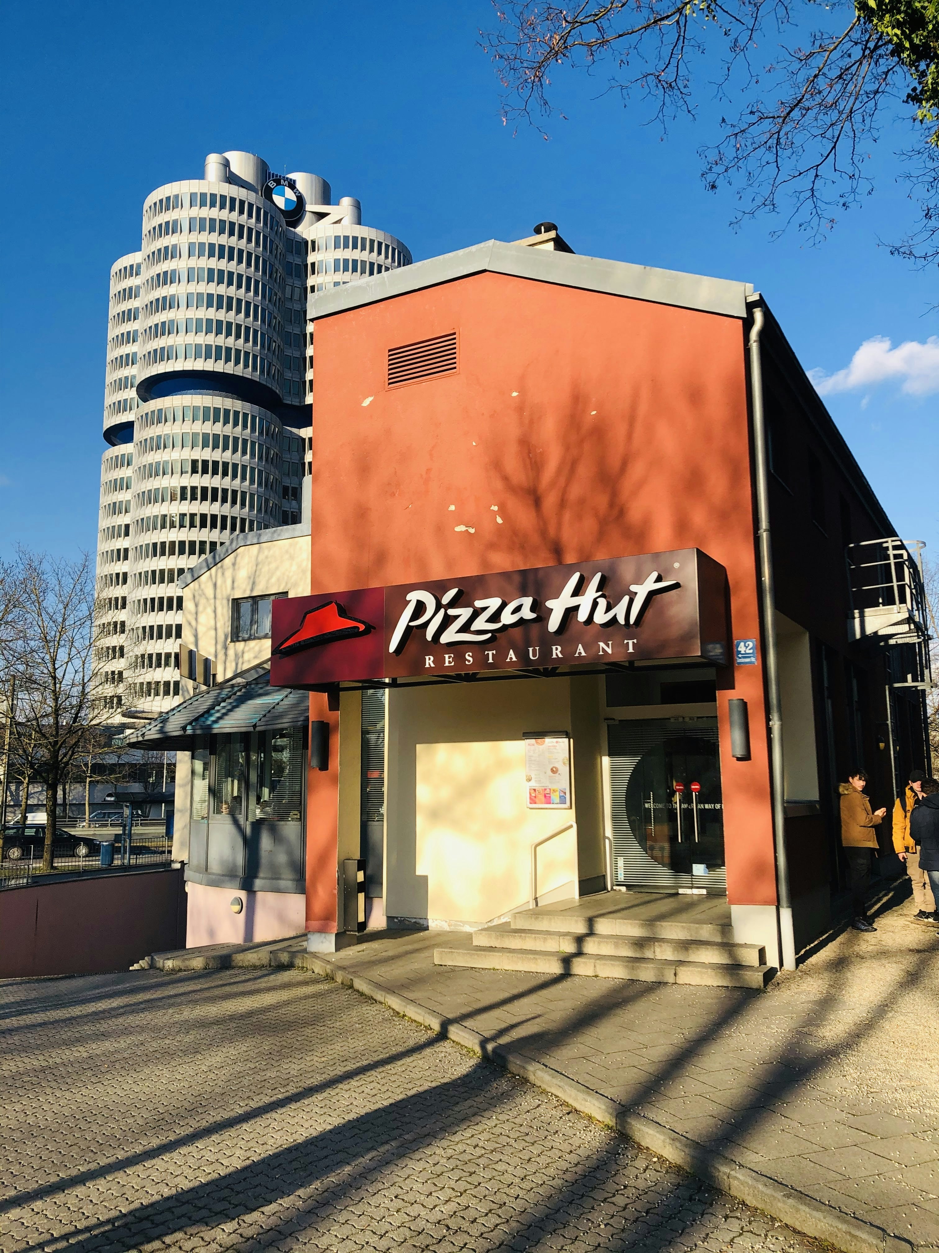 brown and white concrete building during daytime photo free pizza hut am olympiazentrum image on unsplash
