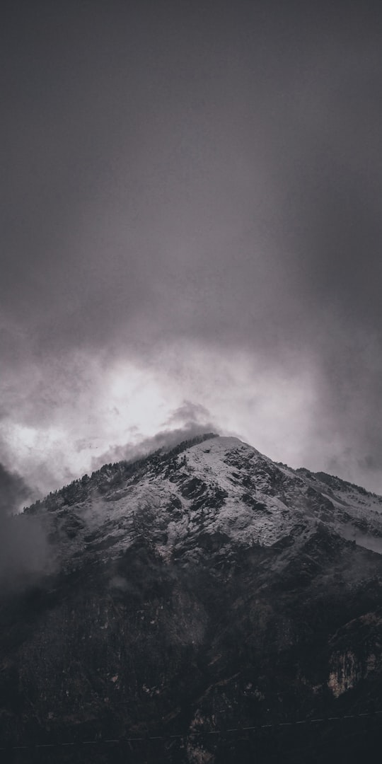 snow covered mountain under cloudy sky in Uttarakhand India