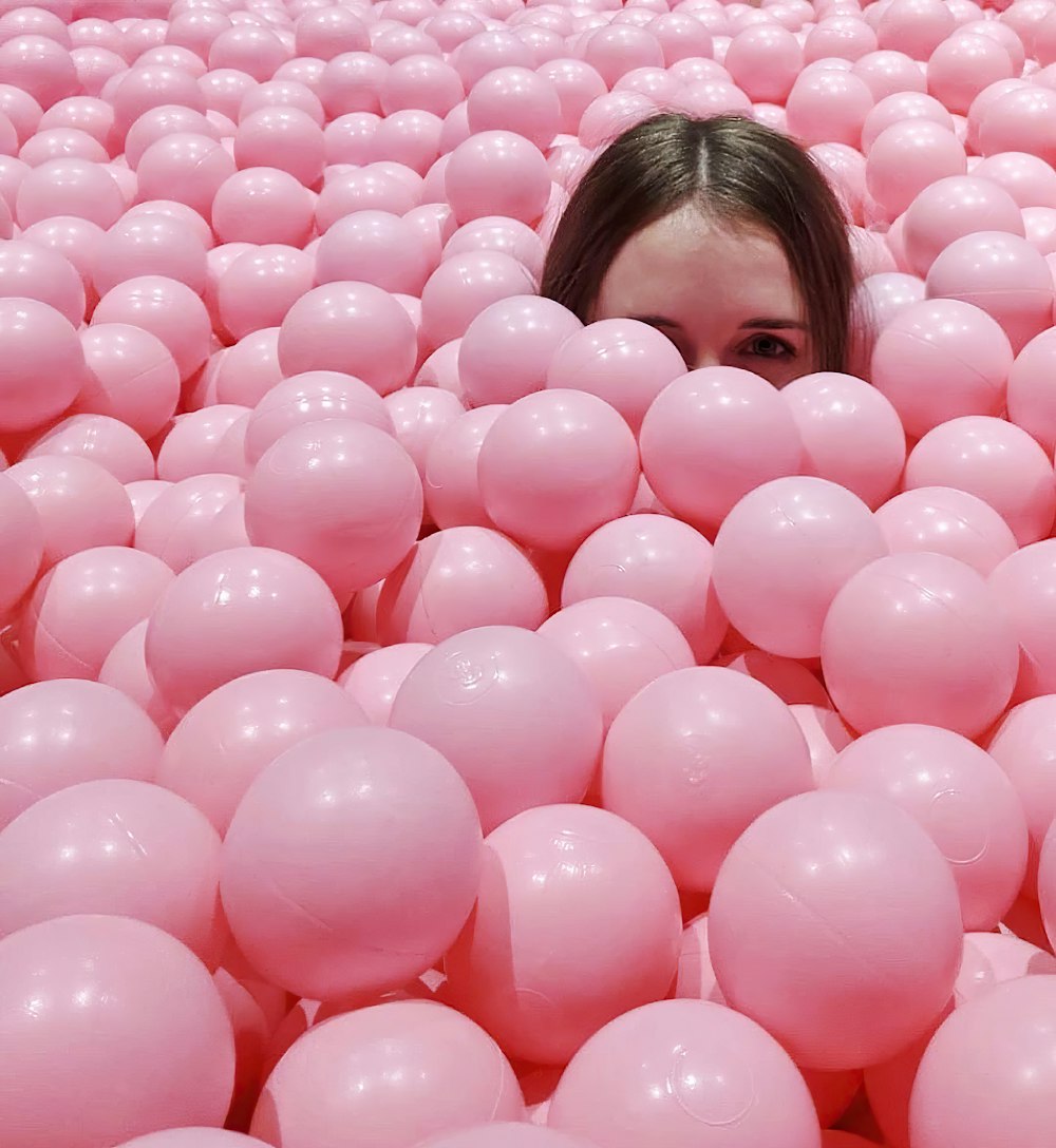 girl in pink shirt standing and smiling