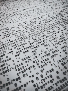 Monochrome high-contrast image of algorithmic code fragments in a chaotic overlay.