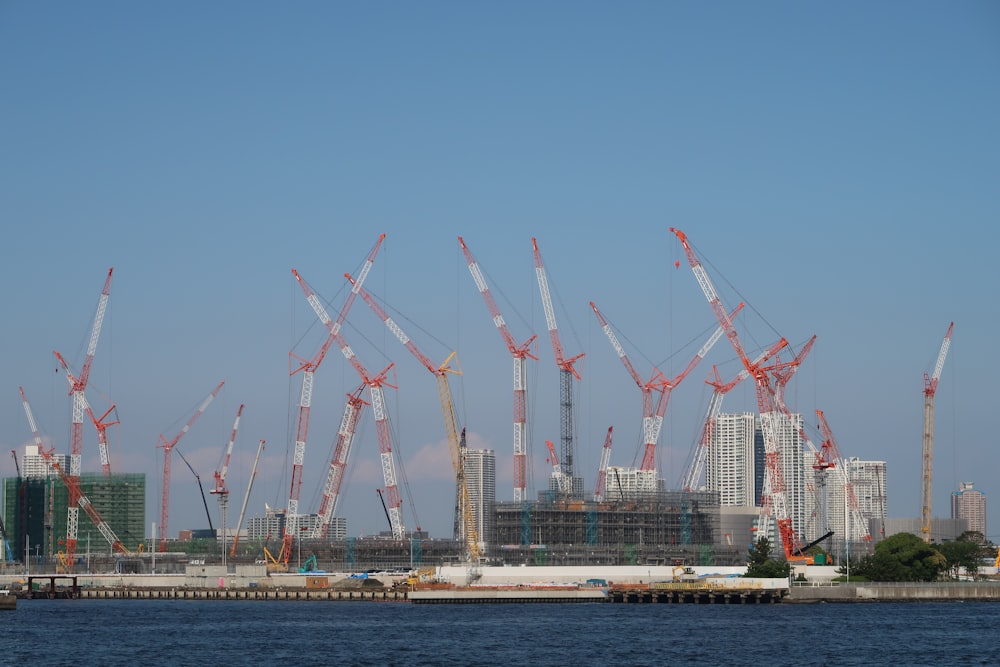 white and red metal towers near body of water during daytime