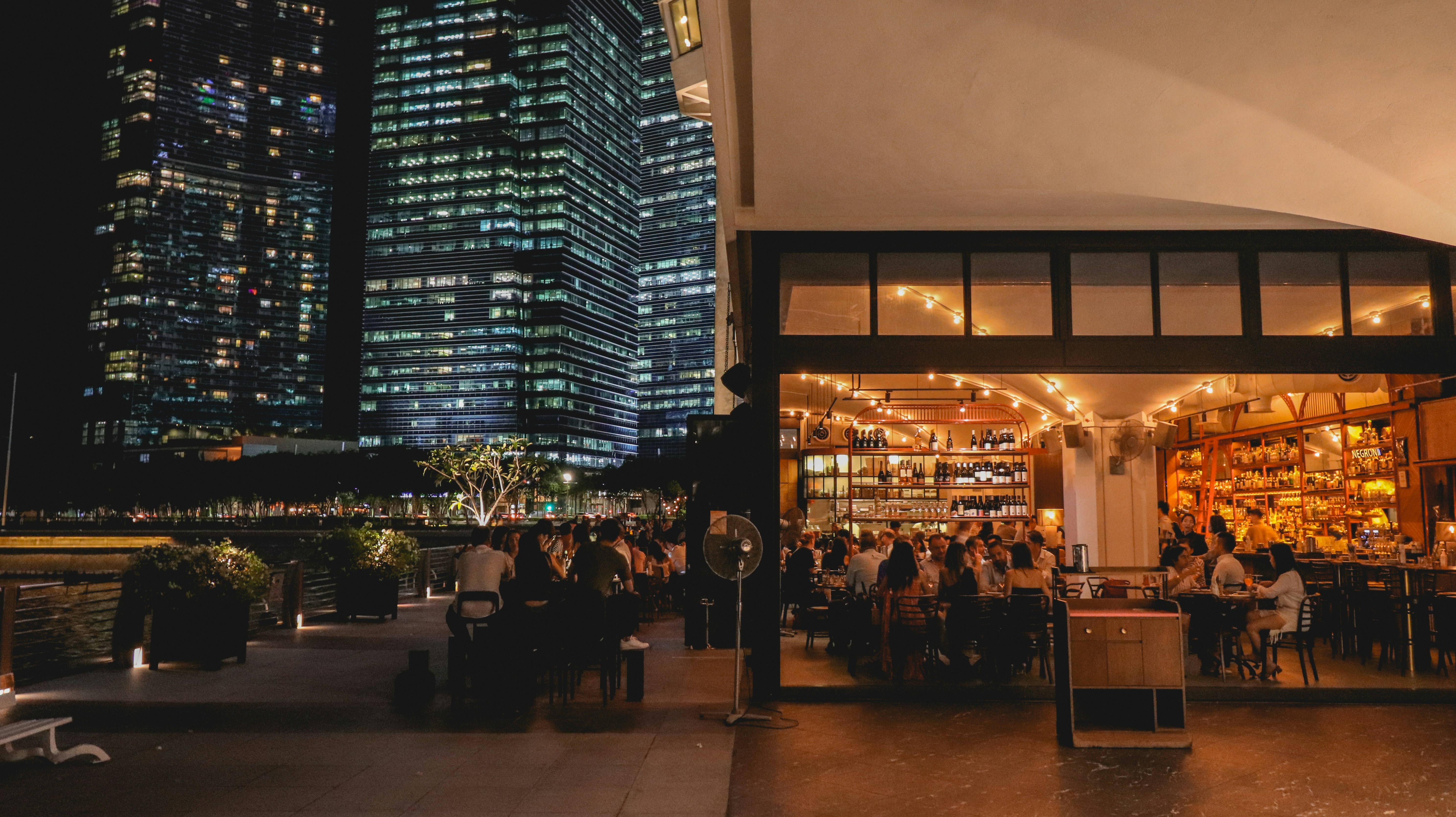 people walking on sidewalk during night time