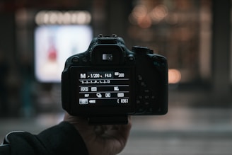 person holding black dslr camera