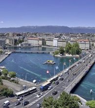 aerial view of city buildings near body of water during daytime